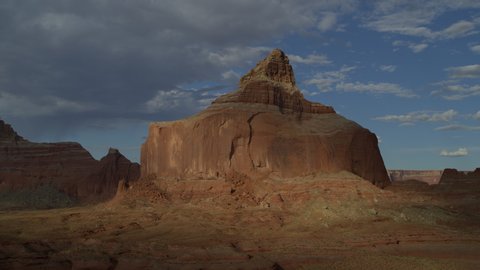 Panning shot of distant desert rock formation / Glen Canyon, Utah, United States