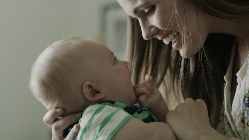 Slow motion close up of mother holding baby son and rubbing noses / American Fork, Utah, United States