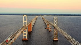Aerial drone footage of Chesapeake Bay Bridge, with camera pull back between the two bridge spans.