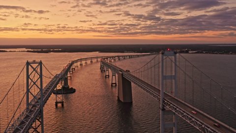 Aerial drone footage of Chesapeake Bay Bridge at dusk, with slow forward camera movement, towards the Annapolis side of the bay