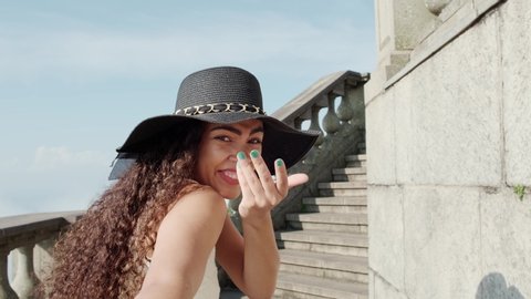 Attractive young beautiful curly-haired girl pulls arm of her boyfriend at a staircase. Tourist couple. POV. Slow motion. Rio de Janeiro, Brazil. Cinematic 4K.