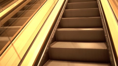 Golden escalator stairs close-up, moving in modern building. empty moving staircase