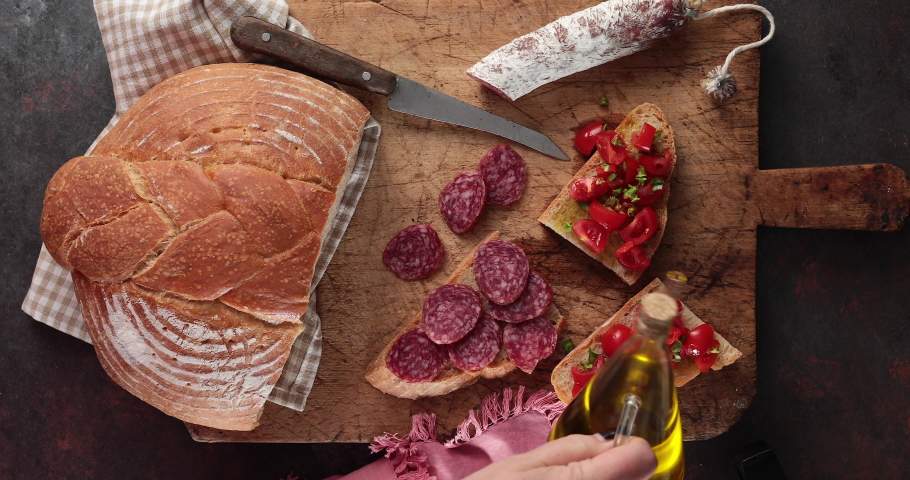 Italian peasant food - Fresh homemade bread seasoned salami and bruschetta with tomato basil and extra virgin olive oil