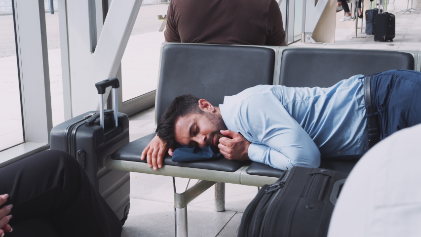 Businessman Sleeping On Seats In Airport Departure Lounge Because Of Delay Royalty-Free Stock Footage #1040019929