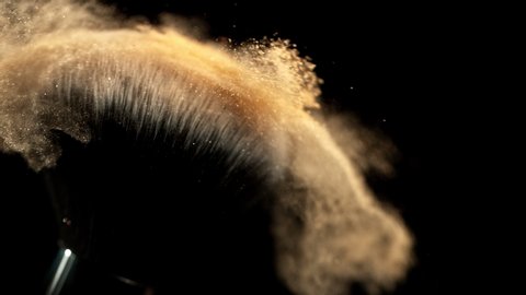 Super Slow Motion Closeup Shot of Makeup Powder Falling from Facial Brush at 1000fps.