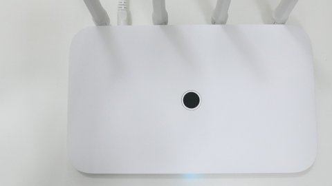 Top View Bokeh White Wireless Wi-Fi Router Antennas On The White Desk Panning Slider Shot.
