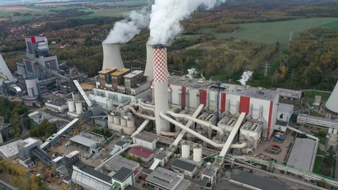 Aerial view of huge coal thermal power plant, steaming chimney and cooling towers - industrial landscape panorama of Europe from above