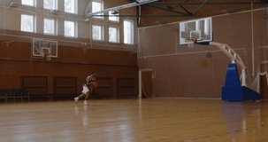 WIDE African American black college male basketball player practicing alley-oops alone on the indoor court. 4K UHD 120 FPS SLOW MOTION RAW Graded footage