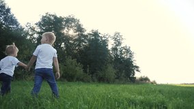 Happy family walking: funny slow motion video little kid boy hold hands go nature play whirl a and girl brother and sister hold hand on nature happy children lifestyle concept. children happy family