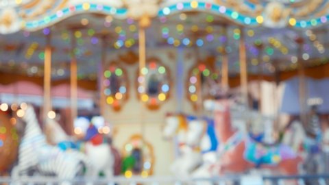 Carousel bokeh of light blurred amusement park background
