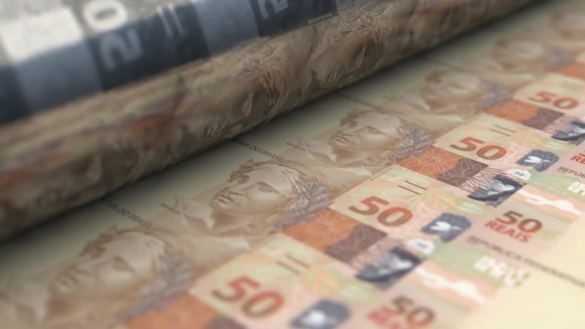A loop able animation concept image showing a long sheet of brazilian real notes going through a print roller in its final phase of a print run | Shutterstock HD Video #1040047760
