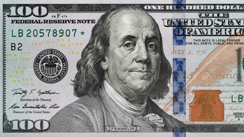 Tracking over US 100 dollar bill. Benjamin Franklin. 4K | Shutterstock HD Video #1040057231