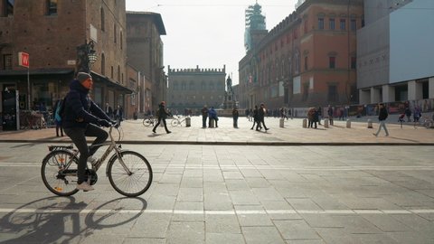 BOLOGNA, ITALY - FEBRUARY 03, 2019: Sightseeing of the city. People at Piazza del Nettuno with medieval Fountain of Neptune, view on sunny winter day