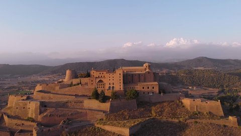 A medieval castle on top of a mountain at sunset. It is the Cardona Castle in Catalonia, Spain.