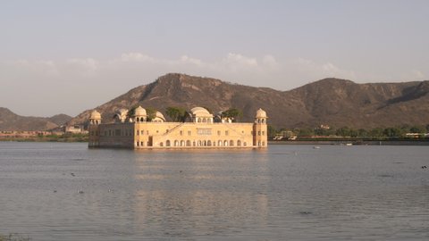 afternoon zoom in shot of the beautiful jal mahal palace and lake man sagar in jaipur, india