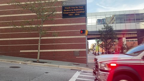Baltimore, MD US October 2019: First responders drive City Fire Department ambulance downtown and turn into ER emergency room drive way at urban hospital Mercy Medical Center 