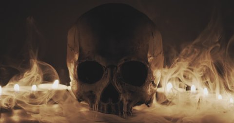 Skull with smoke and candles in slow motion