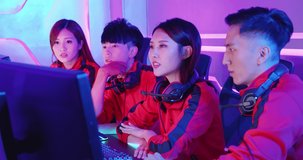 Team of asian teenage cyber sport gamers discuss about their strategy before play in multiplayer PC video game on eSport tournament