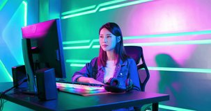 Young asian pro gamer girl wear on headphones and ready to play in online video game