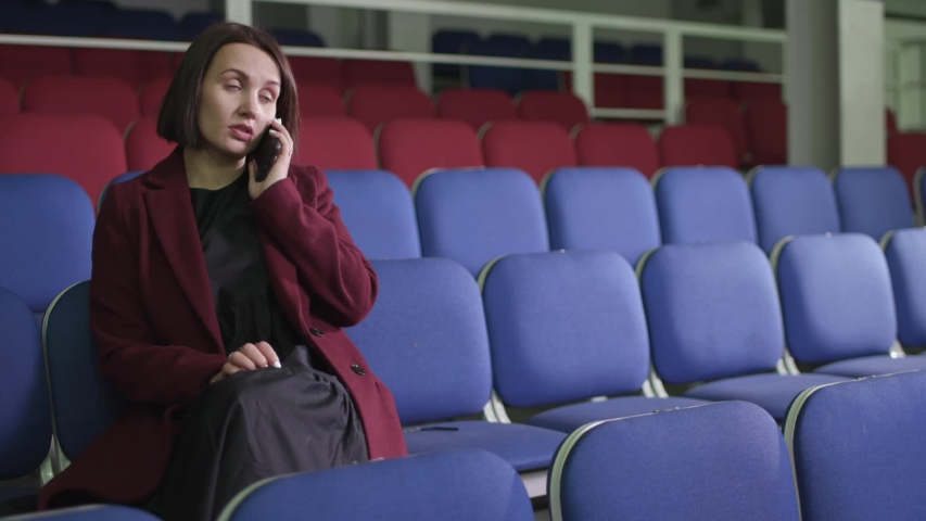 girl on the phone in the stadium	