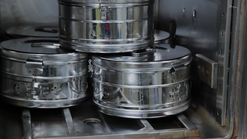 Metal containers for sterilizing medical supplies in an autoclave.