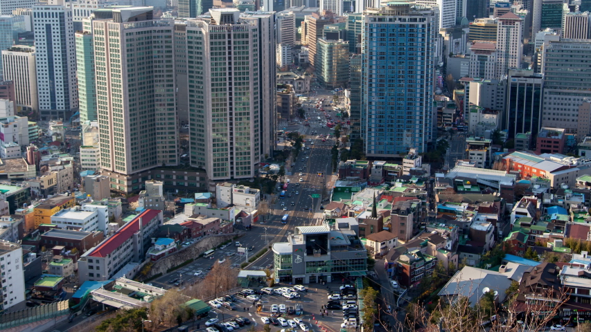 Timelapse Seoul high buildings against hilltop silhouettes, South Korea