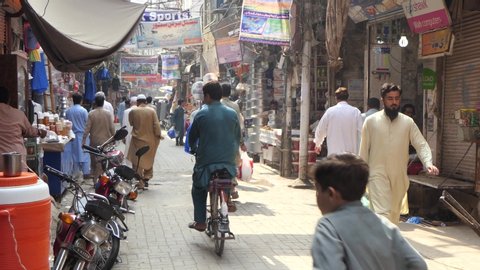 PESHAWAR, PAKISTAN - September 15, 2019: Streetlife in the city of Peshawar. A crowd of people walking in a busy shopping street.