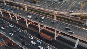 Beautiful aerial view to multi-level highway in Moscow. Camera moving around showing from above the road traffic in a big city on the sunny evening.