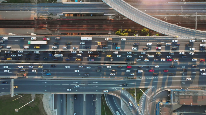 Beautiful aerial view to the cars driving on multi-level highway in Moscow. Direct view from above to the road traffic in a big city on the sunny evening. Royalty-Free Stock Footage #1040122043