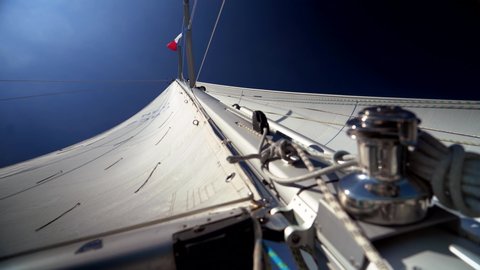 mainsail and foresail catching wind seen from the bottem of the mast 