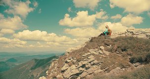 Hiking Woman, tourist, traveler with backpack with her phone camera in hands shooting beautiful mountains landscape view. 4K slow motion video
