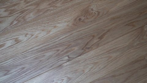 Close-up beautiful solid wood floor Board parquet light oak, slide camera