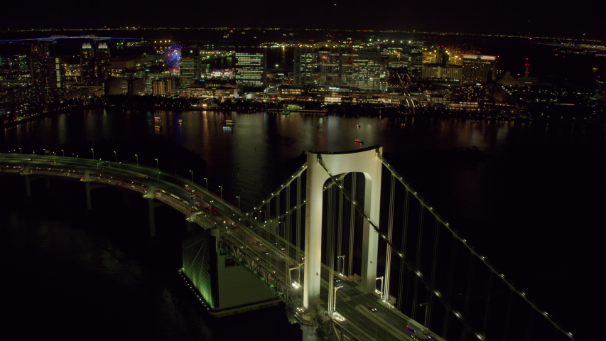 Tokyo, Japan circa-2018. Aerial view of Rainbow Bridge at night. Shot from helicopter with RED camera.