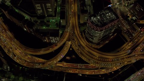 Tokyo, Japan circa-2018. Aerial view of freeway intersection at night. Shot from helicopter with RED camera.