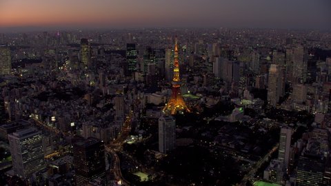 Tokyo, Japan circa-2018. City of Tokyo and Tokyo Tower at dusk. Shot from helicopter with RED camera.