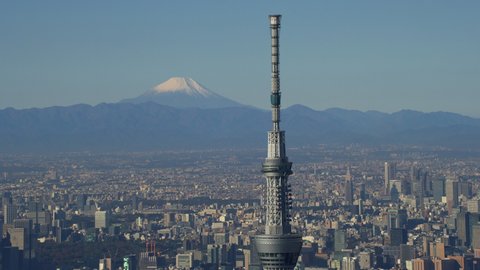 Tokyo, Japan circa-2018. Close up view of Tokyo Skytree with city and Mount Fuji in distance. Shot from helicopter with RED camera.