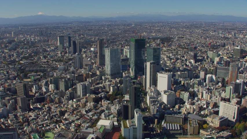 Tokyo, Japan circa-2018. Flying over city of Tokyo with Mt. Fuji in distance. Shot from helicopter with RED camera.