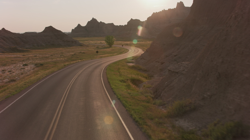 Driving through Badlands National Park at sunset, South Dakota