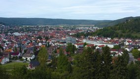 Aerial view of the city Tuttlingen. On a sunny day in summer. Zoom out from the city.