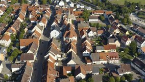 Aerial view of the city Geisingen in Germany. On a sunny day in summer. Pan to the right beside the church.