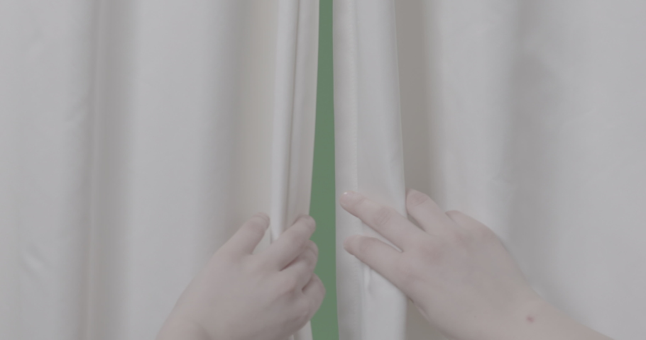Hands pulling a window curtain in front of greenscreen, hands unveiling curtains so you can look out of the window, opening transition or establishing shot, high res ungraded 4k log footage