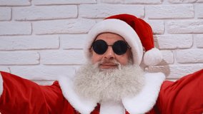 Joyful elder man in red Santa costume with grey beard singing christmas carols while sitting on the floor and keeping wooden numbers of 20. Santa Claus celebrating winter holidays. - Powered by Shutterstock - Get 15% off with code: PIKWIZARD15