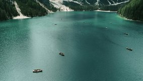 Rowing boats floating on a famous alpine lake Lago di Braies. Tourism mecca Boating on a clear turquoise water ,Dolomites,Italy - Powered by Shutterstock - Get 15% off with code: PIKWIZARD15