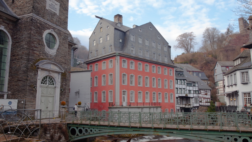 Timelapse of the German Landmark Red House Rotes Haus Monschau With People Crossing The Bridge and Moving Clouds