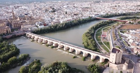 Aerial view of Historic centre of Cordoba with antique Roman Bridge over Guadalquivir river and medieval Mosque-Cathedral, Spain