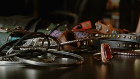 Big pile of imitation jewellry and a golden ring with a pink ruby which is rocking on the desk surface. A concept for a jewel store or a fashion magazine. - Powered by Shutterstock - Get 15% off with code: PIKWIZARD15