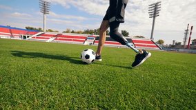 Footballer with a bionic leg is running with a ball - Powered by Shutterstock - Get 15% off with code: PIKWIZARD15