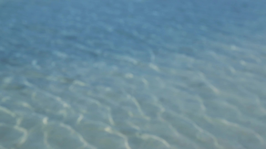 Blurred blue sea wave ripple over the soft sand on the beach | Shutterstock HD Video #1040190653