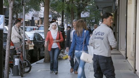 HAMRA STREET, BEIRUT - NOV 2015: Pedestrians walk on the sidewalk. Hamra Street is one of the main economic and diplomatic hubs of Beirut.