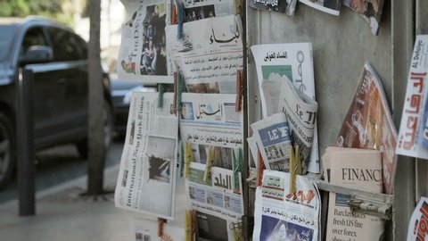BEIRUT, LEBANON - 19 NOV 2015: Tilt up on newsstand, Lebanese newspapers and magazines
